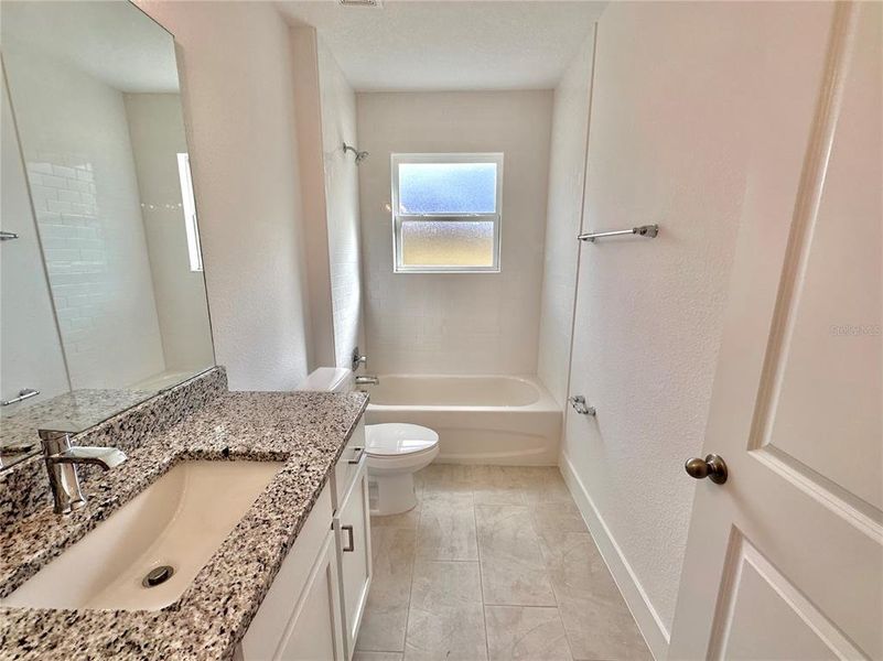 Granite counter & subway tile to ceiling