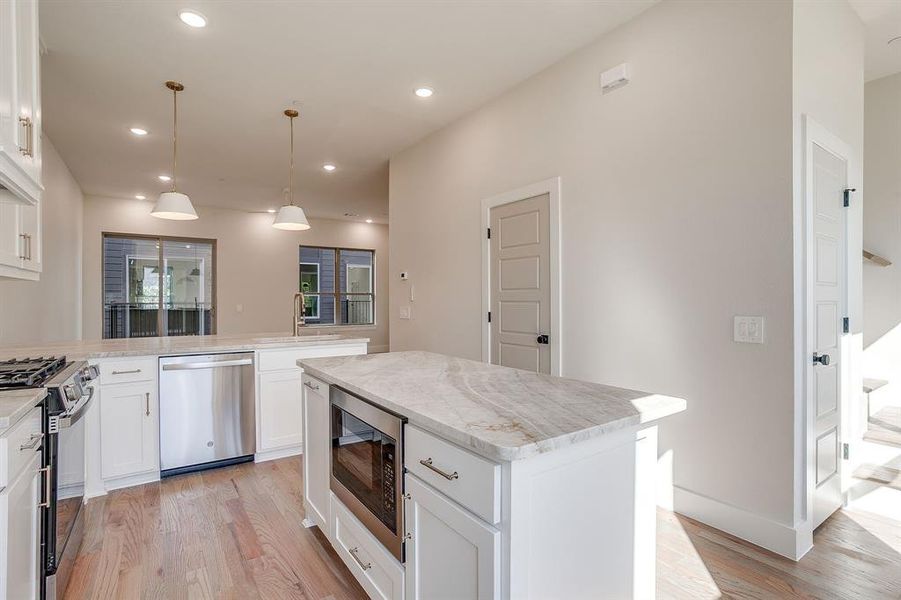 Open-concept kitchen blending style and practicality at Linwood Quarter. Open-concept kitchen blending style and practicality at Linwood Quarter.