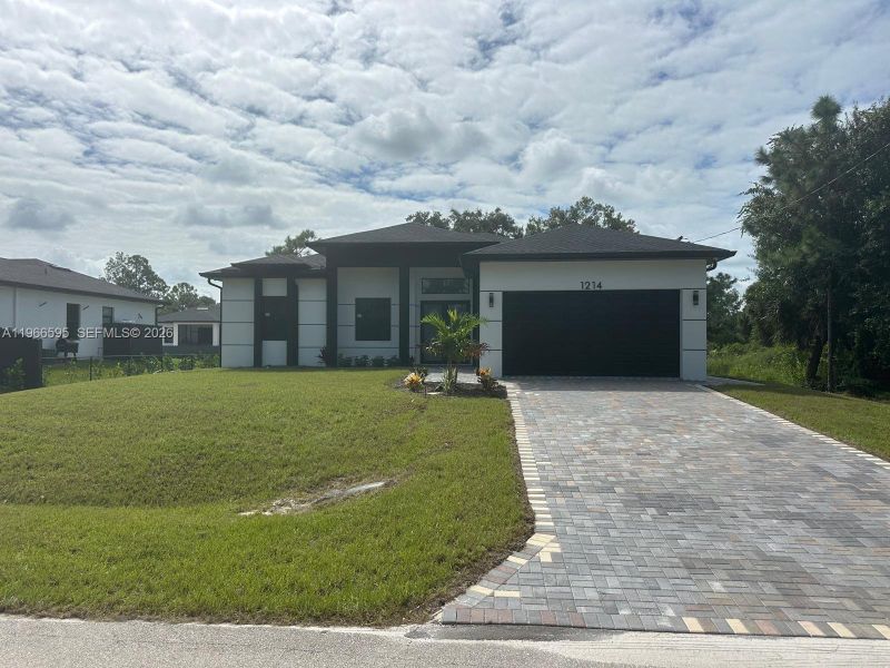 Front exterior of a new home in , Lehigh Acres, FL, highlighting curb appeal (Image 16).