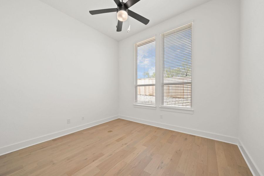 Spare room featuring light wood-type flooring and a ceiling fan