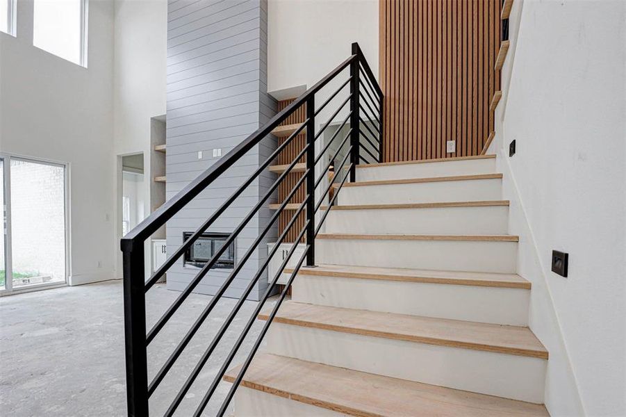 Stairs with a towering ceiling and concrete flooring