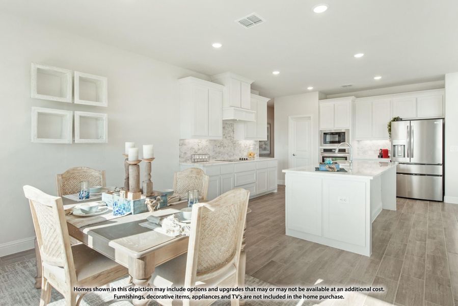 Open-concept kitchen and dining area with white cabinets, center island, stainless appliances, and wood-look floors
