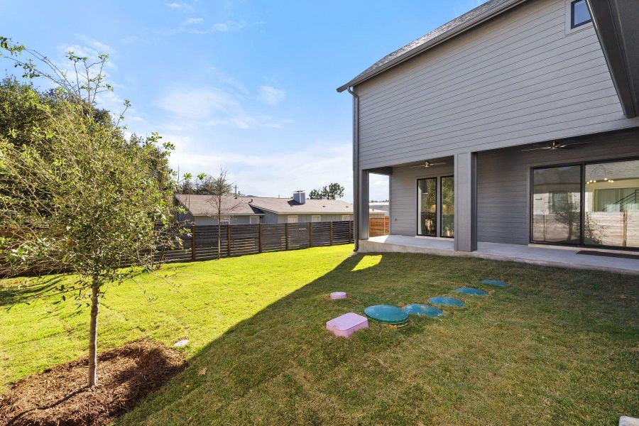 View of yard featuring a ceiling fan, fence, and a patio