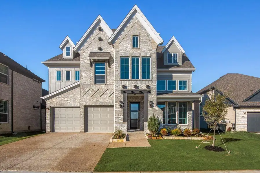 Front exterior of a new home in Justin Crossing, Justin, TX, highlighting curb appeal (Image 1). Front exterior of a new home in Justin Crossing, Justin, TX, highlighting curb appeal (Image 1).