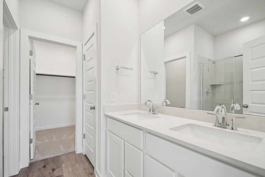 A bathroom with a large mirror.