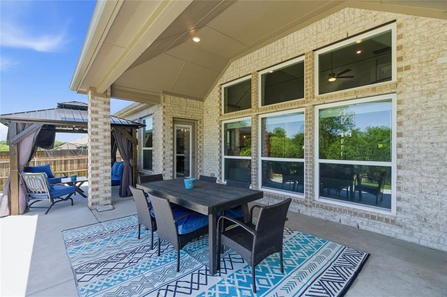 Expansive covered patio featuring a high vaulted ceiling with recessed lighting