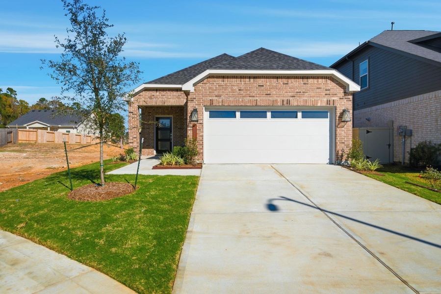Front exterior of a new home in Audubon, Magnolia, TX, highlighting curb appeal (Image 20).