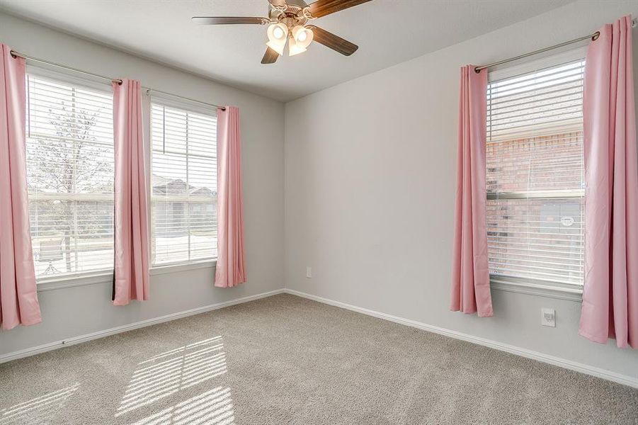 Spare room with carpet and a ceiling fan