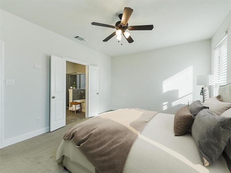 Bedroom with ceiling fan and carpet