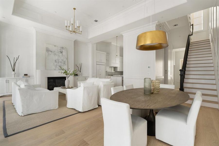 Host effortlessly in this spacious and light-filled living area, where luxury and functionality meet with impeccable craftsmanship and a seamless connection to the rest of the home. (photo of interior model home with smaller floor plan)