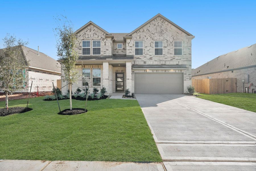 Front exterior of a new home in Martha's Vineyard, Alvin, TX, highlighting curb appeal (Image 2).