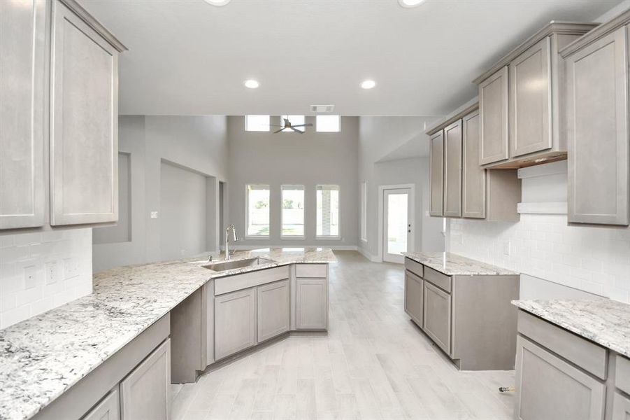 The kitchen is a culinary haven, featuring granite countertops, a tile backsplash, stainlesssteel appliances, and 42” upper cabinets.