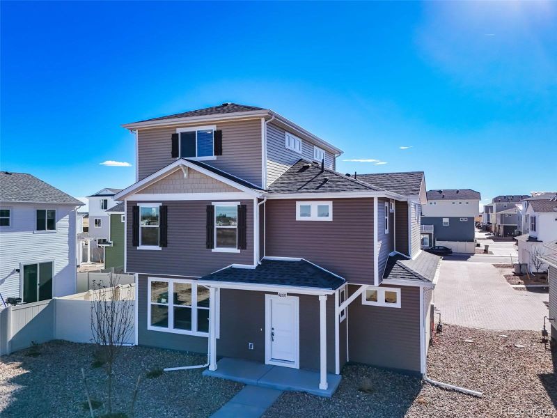Front exterior of a new home in Muegge Farms, Bennett, CO, highlighting curb appeal (Image 24).