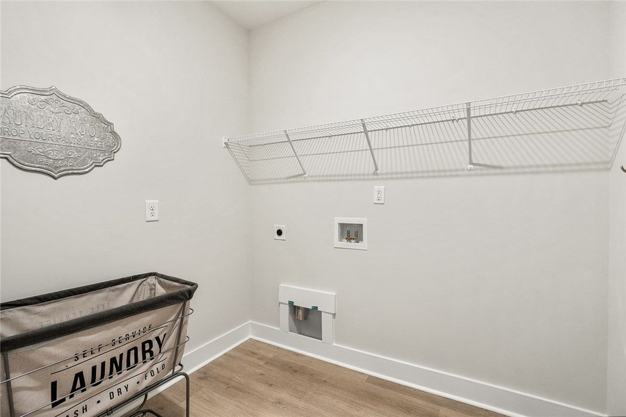 A dedicated utility space with wood flooring and p A dedicated utility space with wood flooring and p