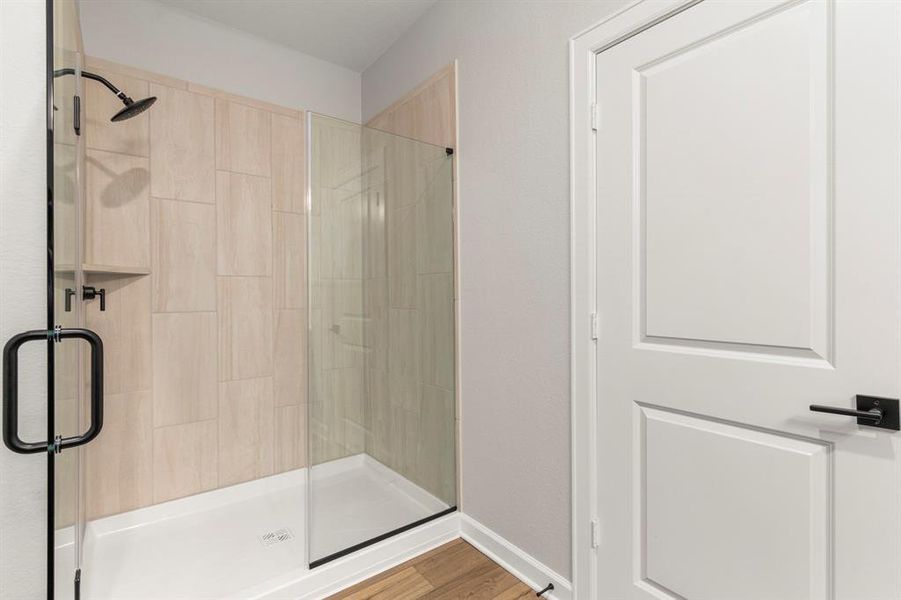 The master bathroom features large tiled walk in shower.