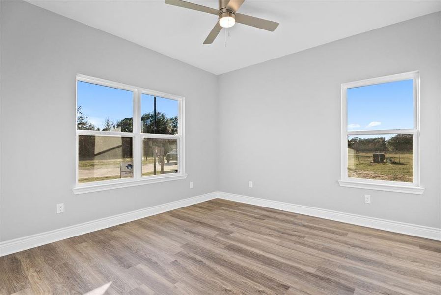 Unfurnished room featuring wood finished floors and ceiling fan