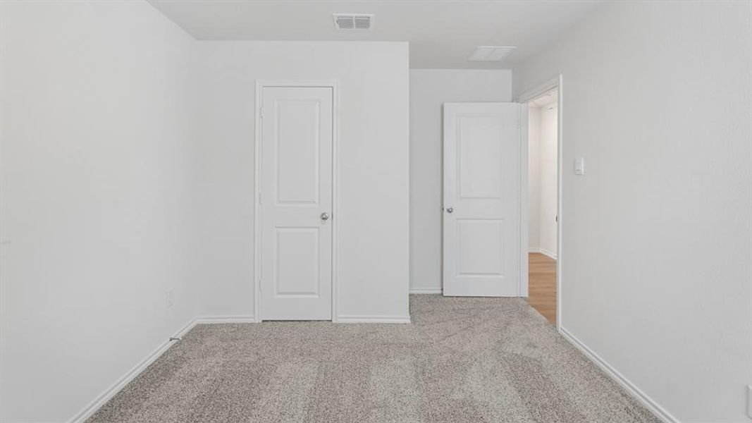 Neutral-toned carpeting and light wall paint throughout