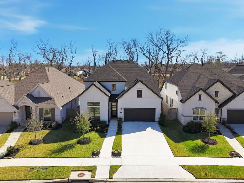 Front exterior of a new home in Sienna, Missouri City, TX, highlighting curb appeal (Image 24).