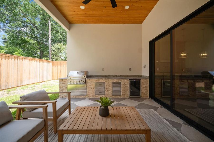 Deck with area for grilling, ceiling fan, a patio, and an outdoor hangout area