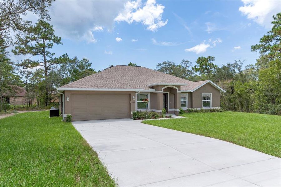 Front exterior of a new home in , Weeki Wachee, FL, highlighting curb appeal (Image 19). Front exterior of a new home in , Weeki Wachee, FL, highlighting curb appeal (Image 19).