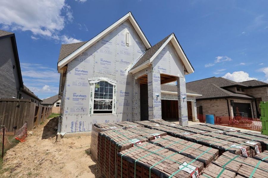 Front exterior of a new home in Riceland 50’ Front Load Homesites, Mont Belvieu, TX, highlighting curb appeal (Image 2).