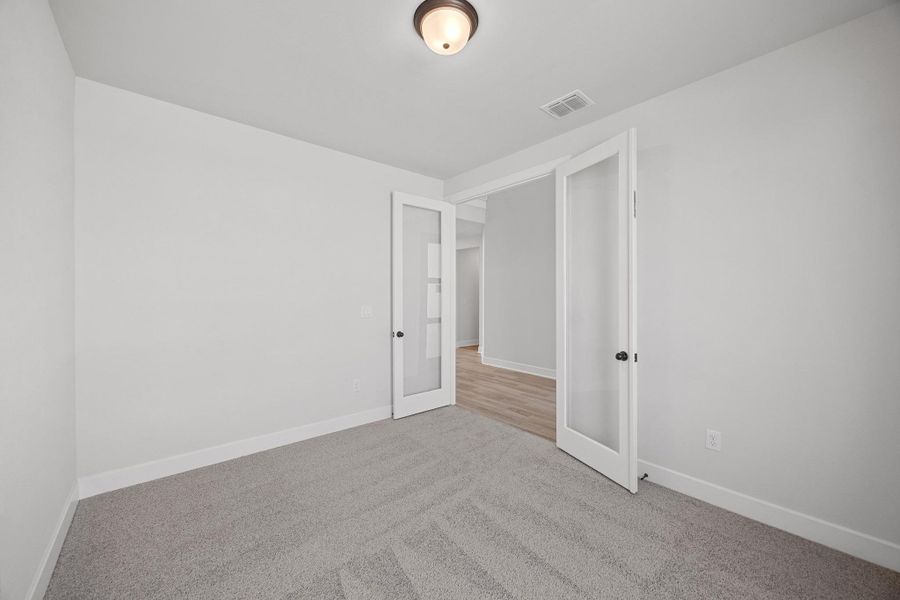 Spare room featuring visible vents, baseboards, and carpet Spare room featuring visible vents, baseboards, and carpet