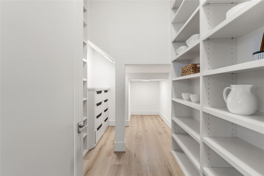 The spacious walk-in pantry. A series of shelves is ideal for pastas, canned goods, and baking materials; drawers are perfect for bulk items and extra pots and pans.   The ‘way back’ will be perfect for sporadically used entertaining items.