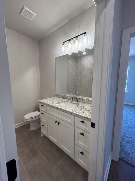 Bathroom with tile patterned flooring, vanity, and toilet