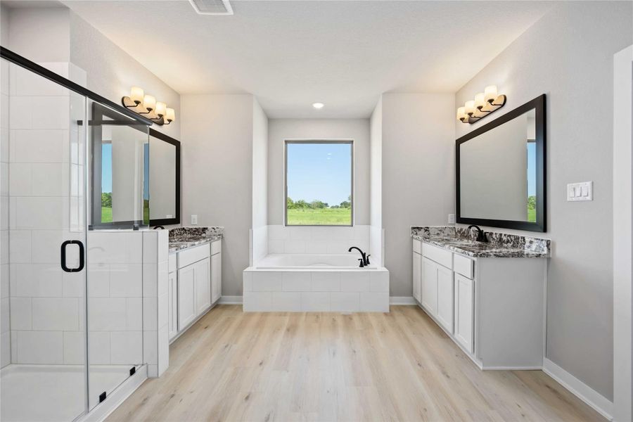 The luxurious owner's retreat is a private oasis with a spa-inspired bath and an extended walk-in closet.