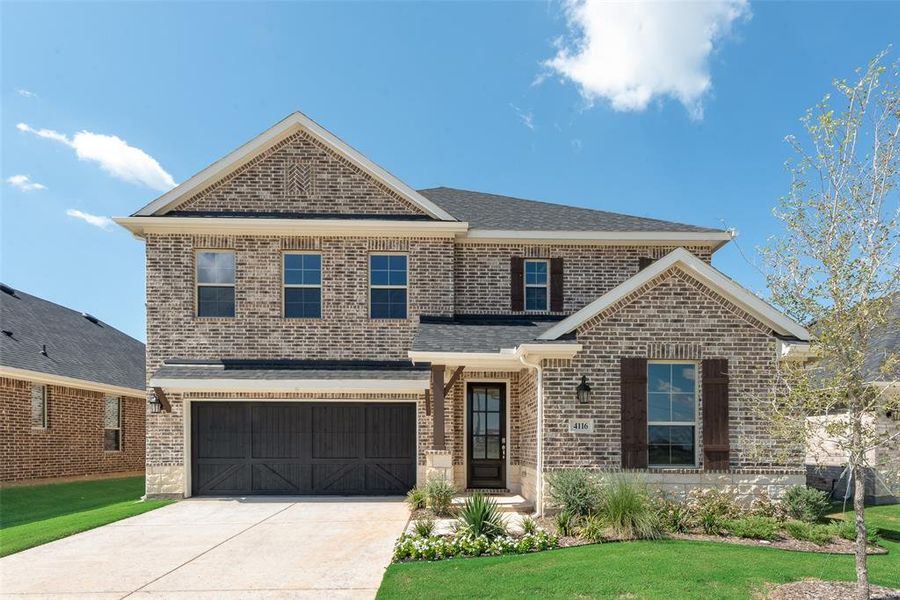 Front exterior of a new home in Spiritas Ranch, Little Elm, TX, highlighting curb appeal (Image 2).