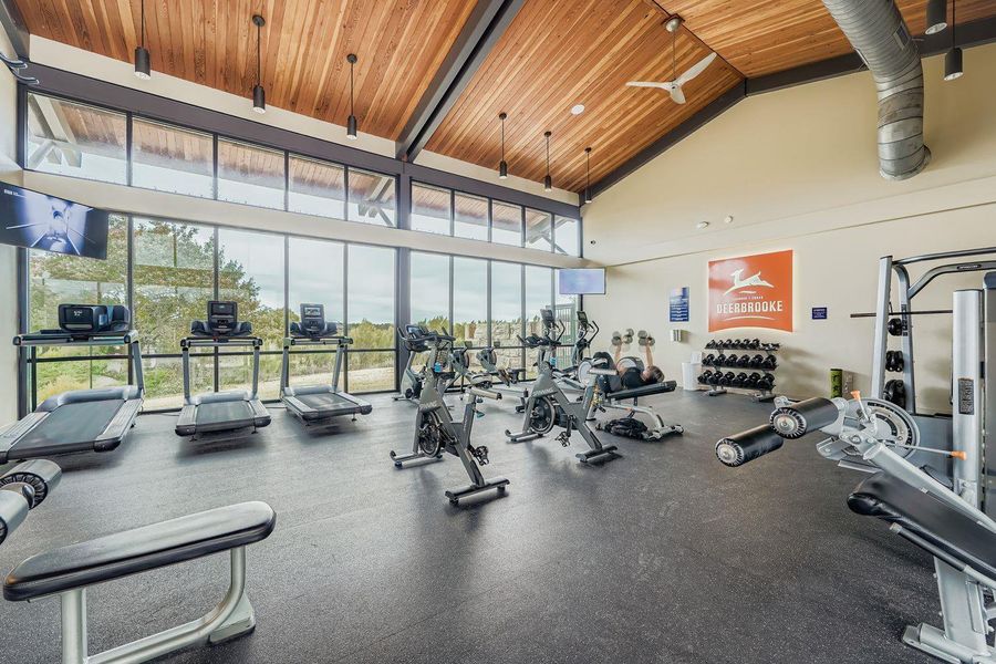Gym with high vaulted ceiling, floor to ceiling windows, and wood ceiling Gym with high vaulted ceiling, floor to ceiling windows, and wood ceiling