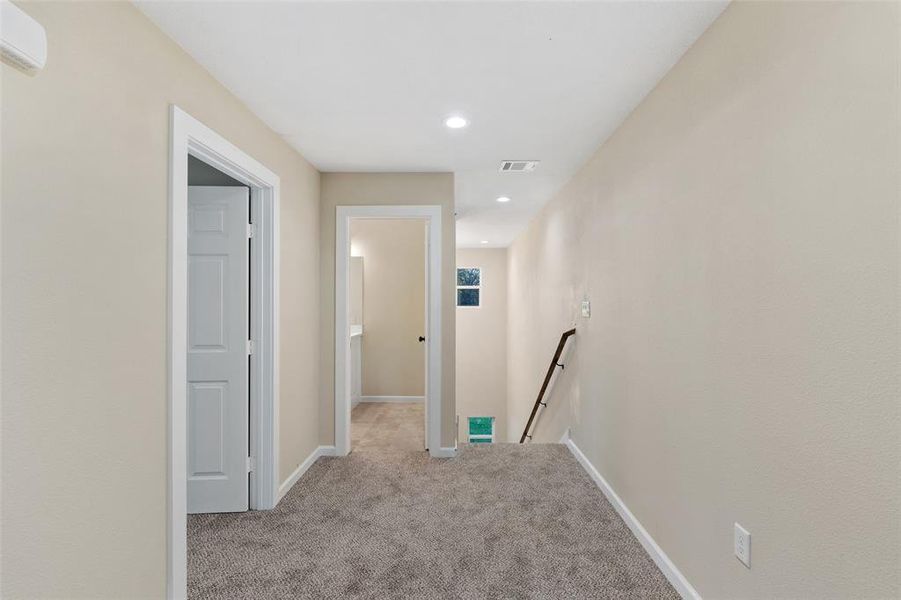 Hallway with light colored carpet