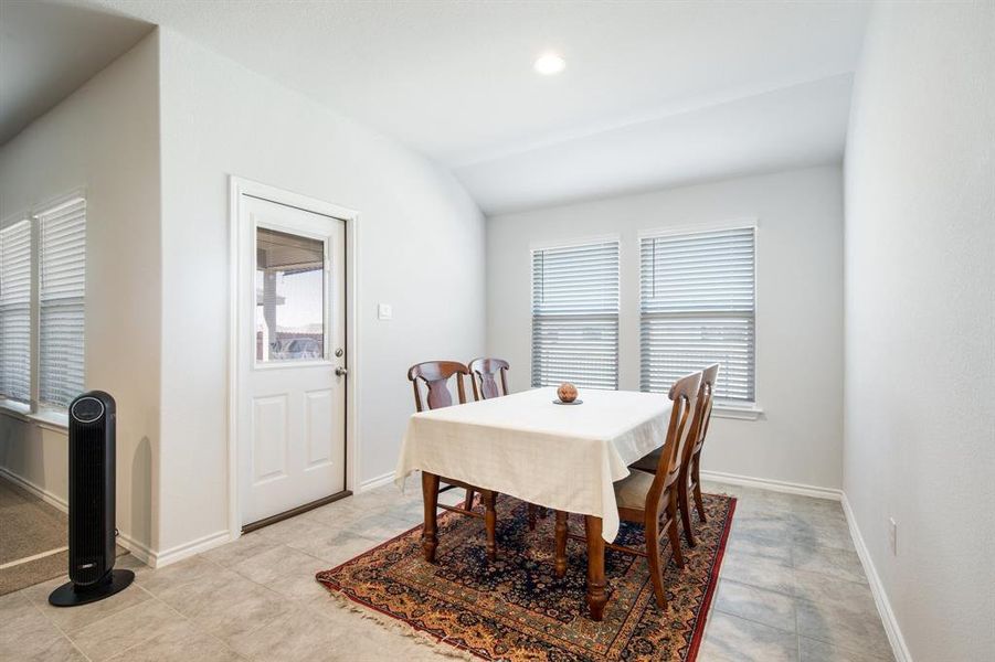 Dining room with recessed lighting, lofted ceiling, and baseboards