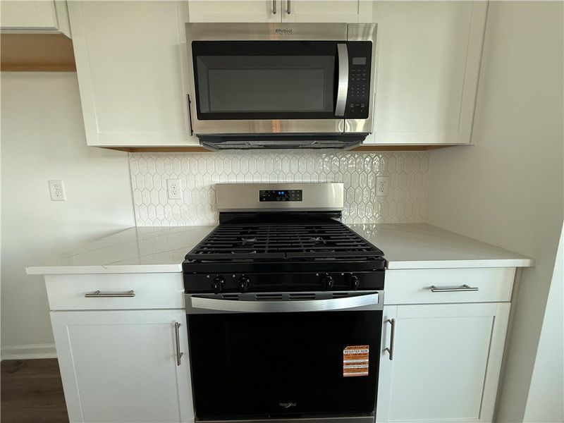 A well-appointed kitchen features a gas range and A well-appointed kitchen features a gas range and