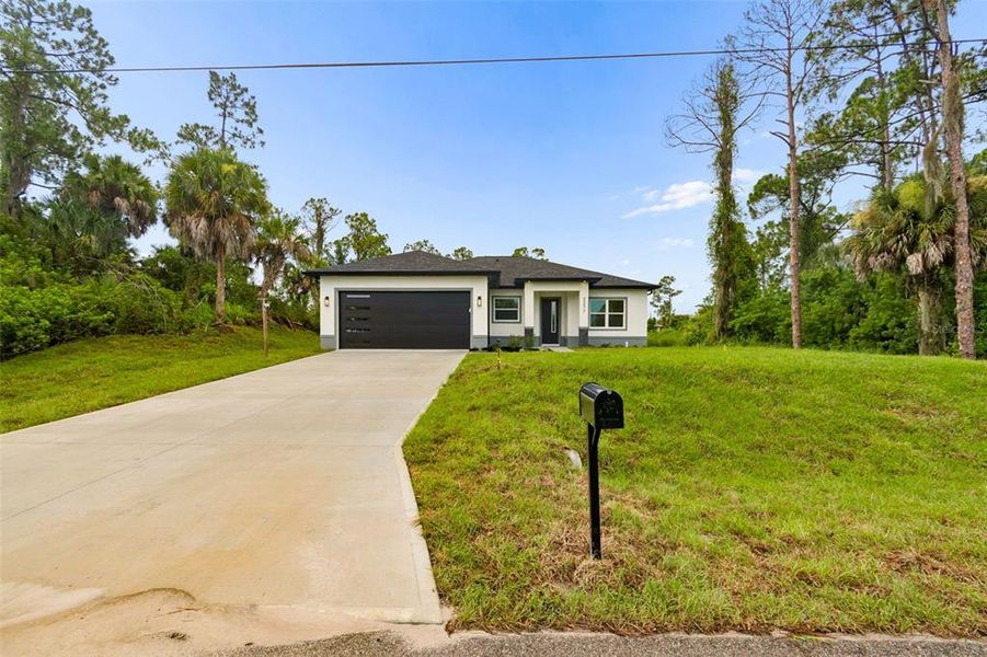Front exterior of a new home in , North Port, FL, highlighting curb appeal (Image 30). Front exterior of a new home in , North Port, FL, highlighting curb appeal (Image 30).
