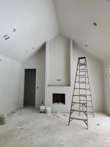 Large Den w/vaulted ceinings and cozy fireplace looking from the kitchen Large Den w/vaulted ceinings and cozy fireplace looking from the kitchen