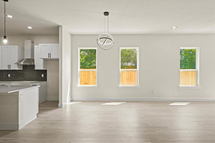 Unfurnished dining area featuring recessed lighting and light wood-style floors Unfurnished dining area featuring recessed lighting and light wood-style floors