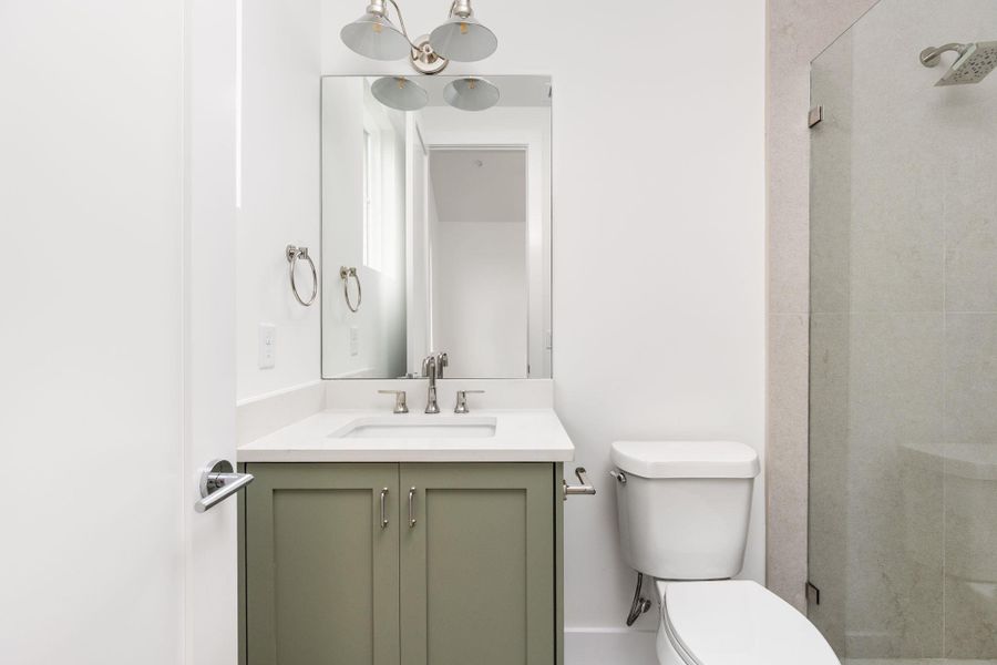 Bathroom featuring vanity and a shower stall