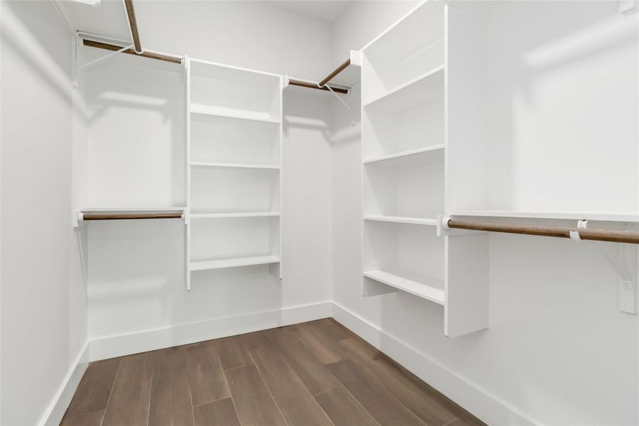 Primary walk-in closet with built-in shelving