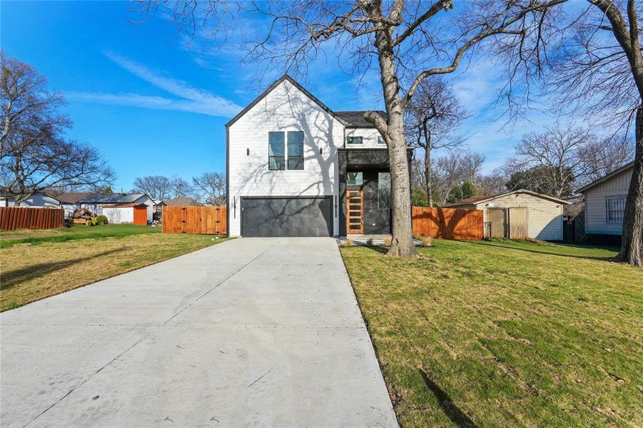 View of front of property with concrete driveway, stairway, a garage, and a gate View of front of property with concrete driveway, stairway, a garage, and a gate