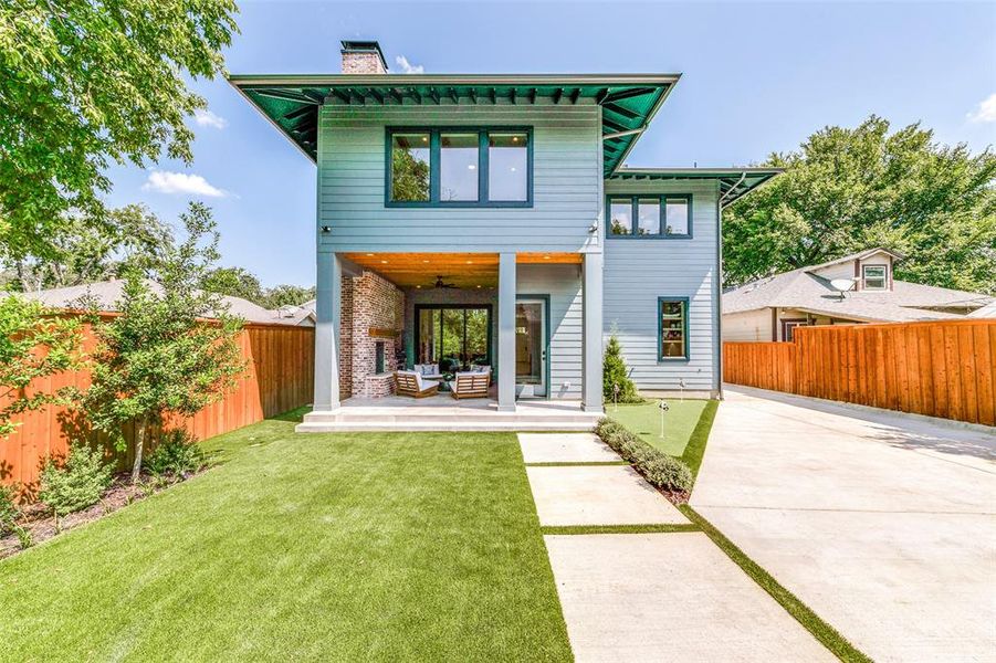 Rear view of house featuring a lawn