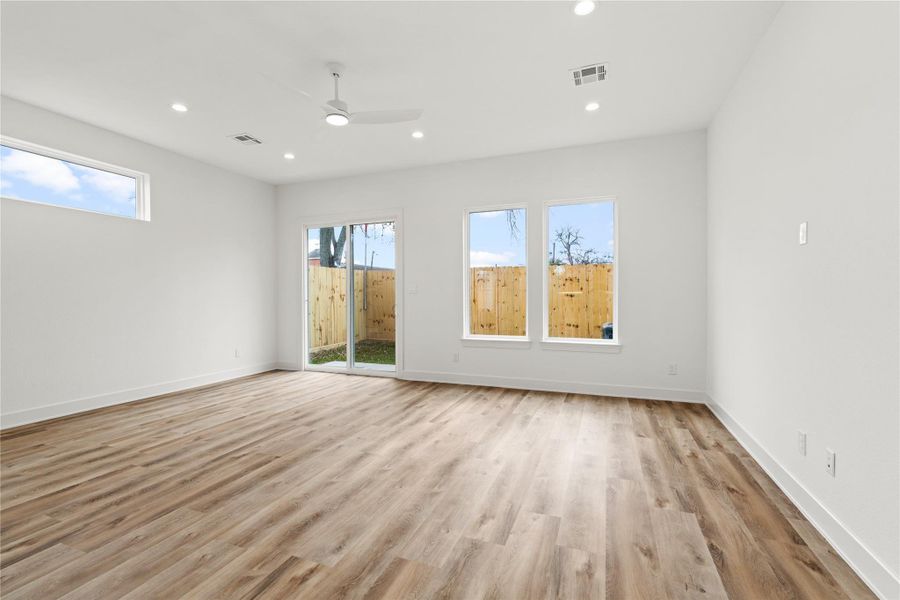 Open living space with wide-plank floors and easy access to the backyard.