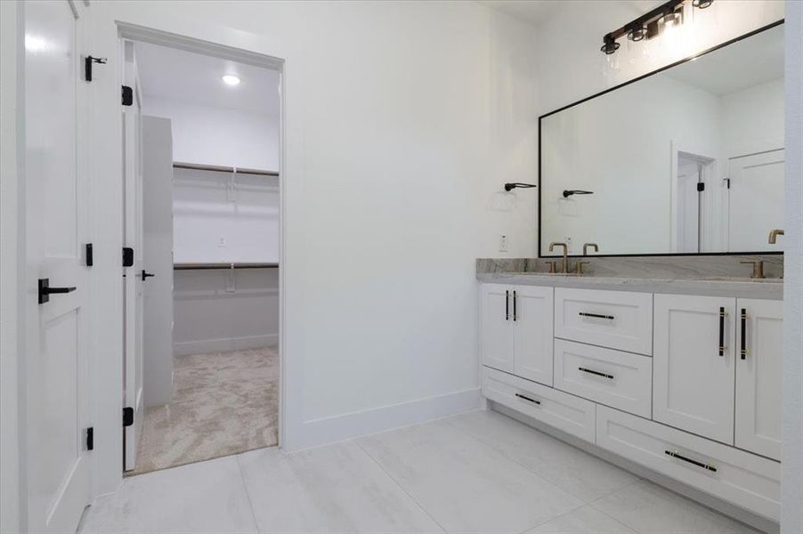 Bathroom with tile floors and dual vanity