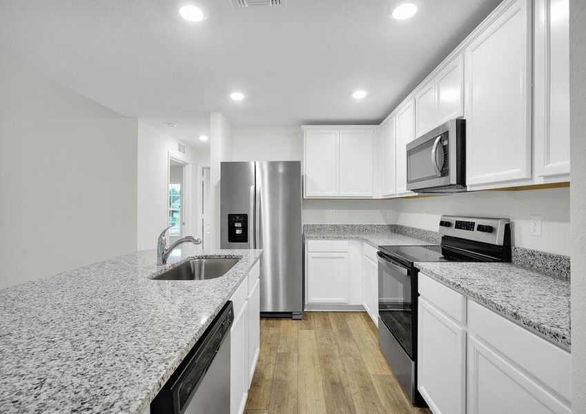 The kitchen is chef-ready with stainless steel appliances