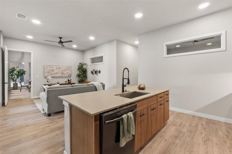 Kitchen with dishwasher, light wood-type flooring, recessed lighting, a kitchen island with sink, and a ceiling fan