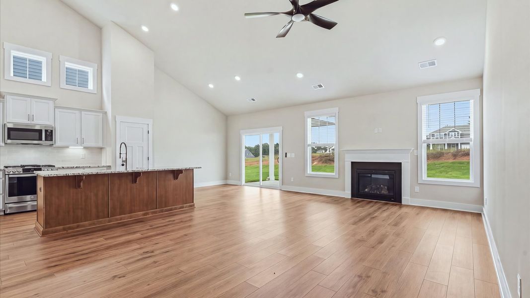 Elegant family room with soaring two-story ceilings and abundant natural light in this first-class DRB Homes design