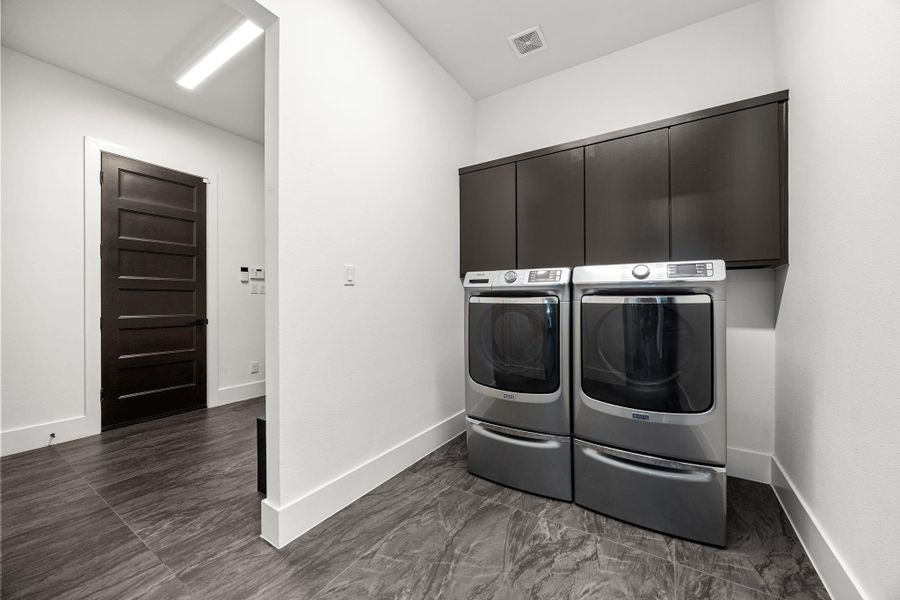 Large utility room with a mud room right around the corner from the garage entrance Large utility room with a mud room right around the corner from the garage entrance