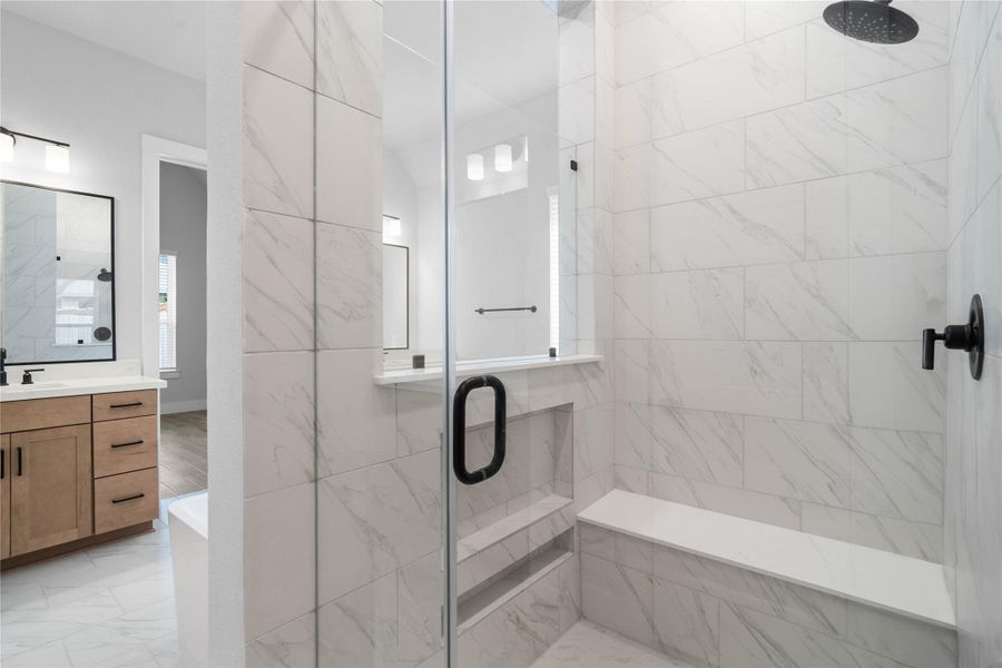 Enjoy a spa-like experience in this modern walk-in shower with tile surround - featuring a built in seat and niche area for bathing supplies.