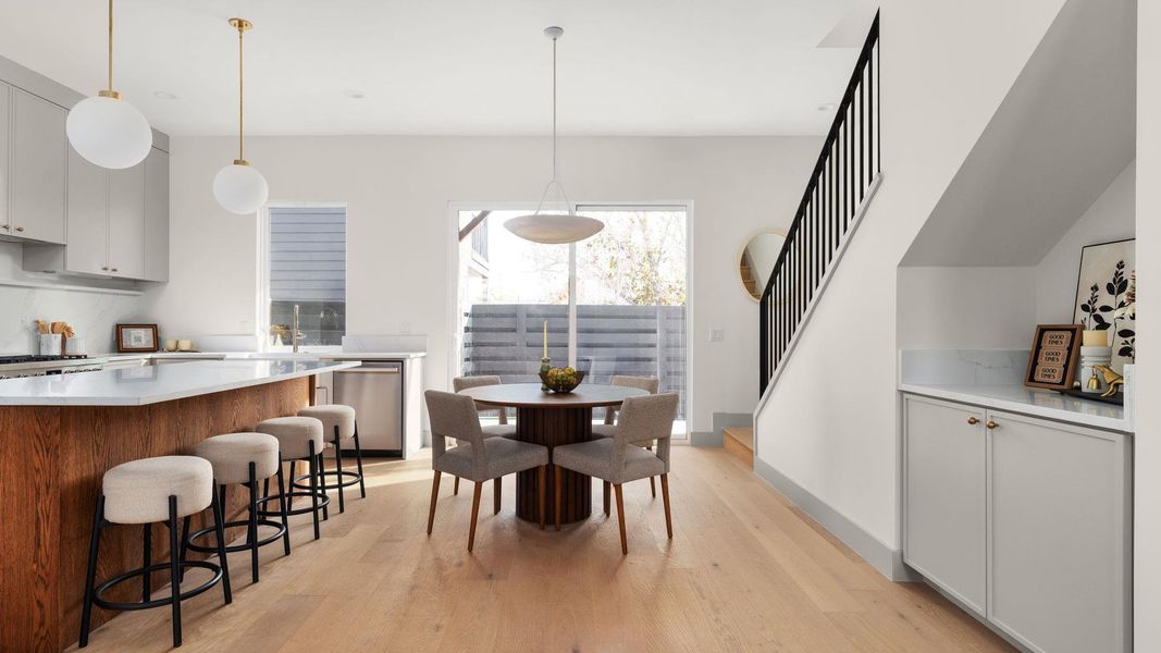 Dining space featuring stairway and light wood-style flooring