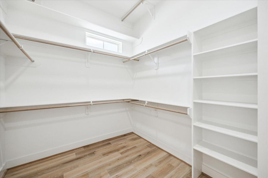 Primary closet with custom shelving.